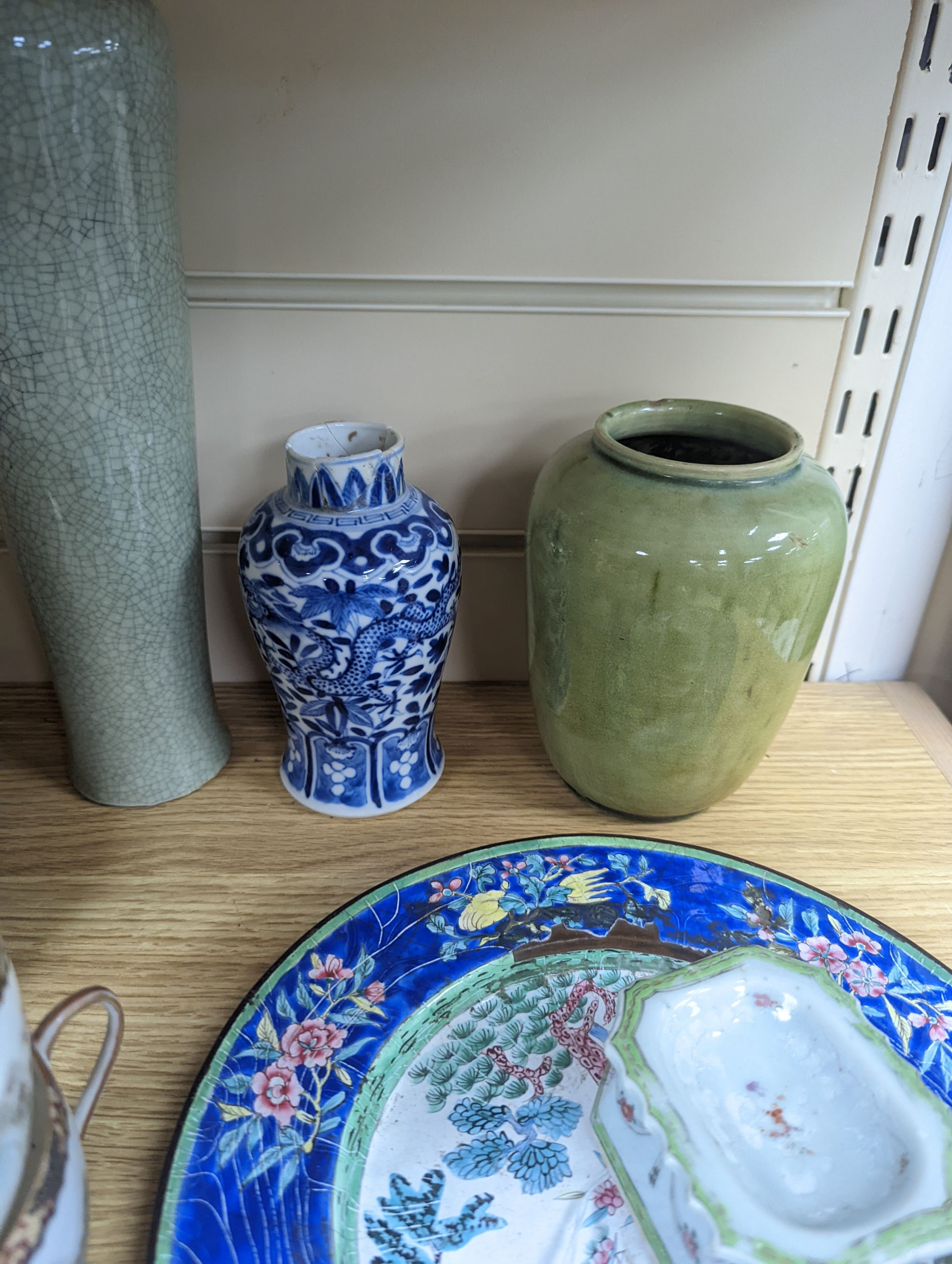 A Chinese Canton enamel dish, 22.5cm, a Chinese famille rose salt cellar, Qing dynasty, two Chinese blue and white vases and a slender crackle glaze vase, Qing and later, 30cm, assorted Chinese ceramics, a lacquered comp
